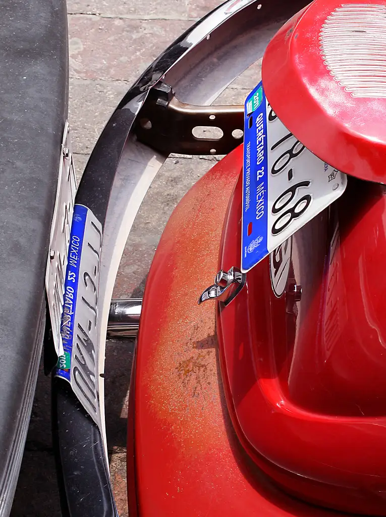 Close-up of a car wheel with exposed lug nuts and hub area under inspection