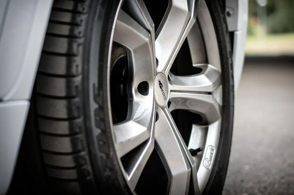 Alloy wheel with salt residue and small chips in winter daylight
