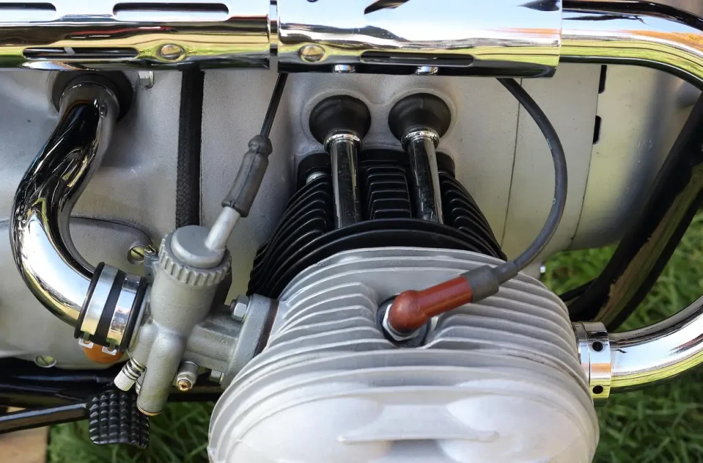 Mechanic inspecting spark plug wires and spark plugs in a sedan engine bay