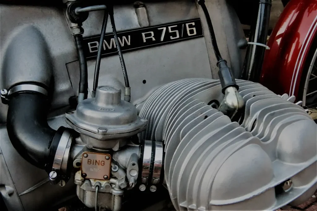 Mechanic removing spark plugs from a cooled engine in a home garage
